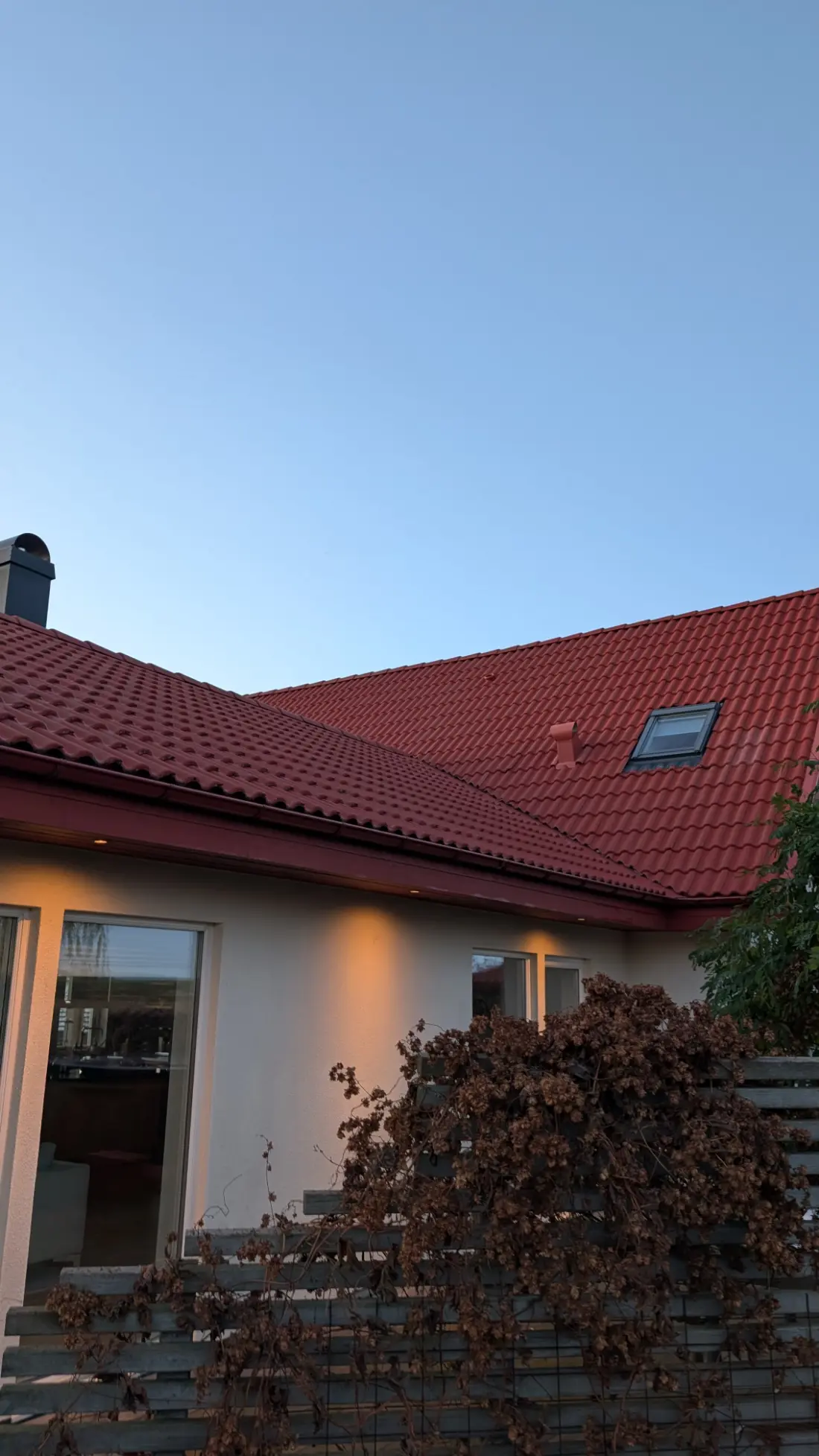 Mättat rött tegeltak mot molnhimmel